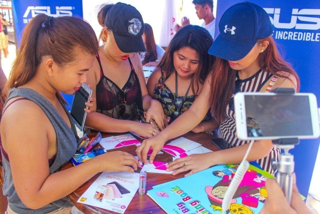 Beach-goers try to form the BeautyLive App logo as they are being livestreamed by the Zenfone Live